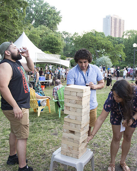 Three guests playing Big Jenga at Craft Brews at the Zoo