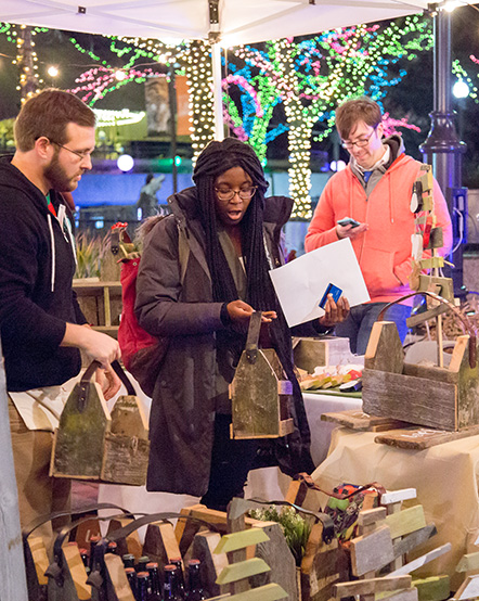 Guests browsing crafts at Holiday Market