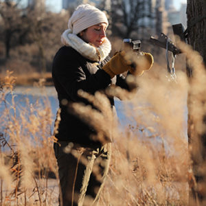 Zoo scientist installing a motion-activated field camera in Chicago