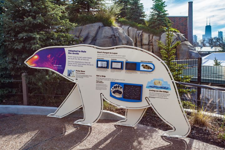 A polar bear-shaped sign at Walter Family Arctic Tundra explaining the physical characteristics of polar bears