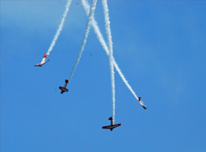 Four planes flying through a blue sky during the Chicago Air and Water Show