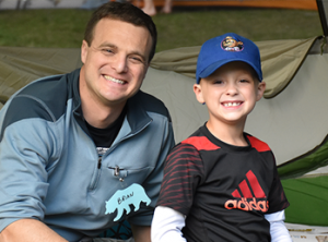 An adult and child enjoying Campout at the Zoo