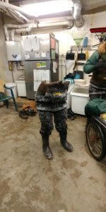 An Animal Care staff member's pants, frozen solid after a cold winter day, standing by themselves