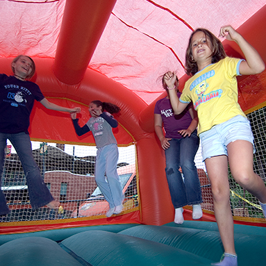 Children bounce in a bounce house