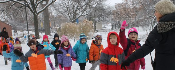 Camp children walk across the snow-covered zoo