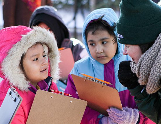 A zoo educators talking to young guests