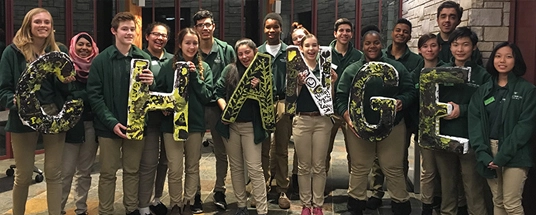 Collection of students holding sign