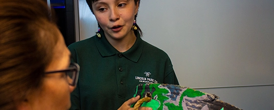 Woman showing book to child