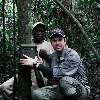 Zoo scientists setting up a motion-activated field camera in the African rainforest