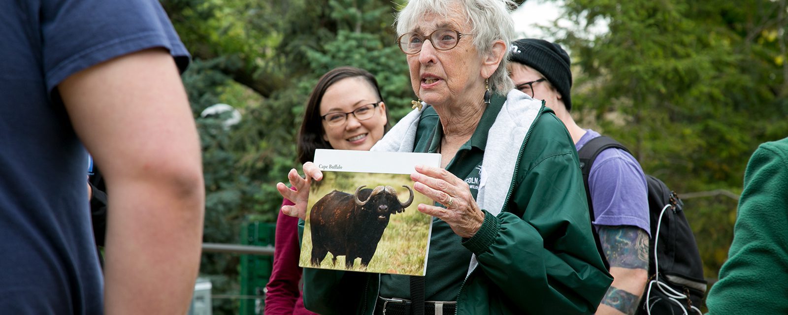 Zoo educator hols a picture of a bison
