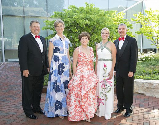 Women's Board members pose for a photo with Board of Trustees Chairman Biff Bowman and zoo CEO and President Kevin Bell