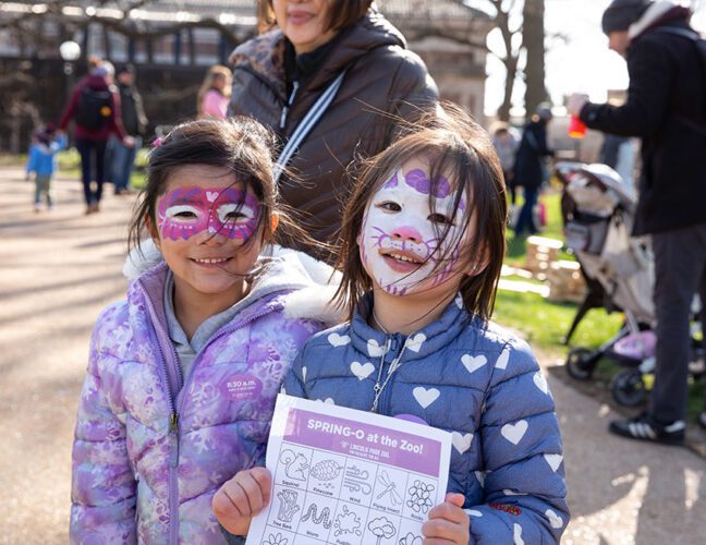 Two young girls with their faces painted during an Easter event.
