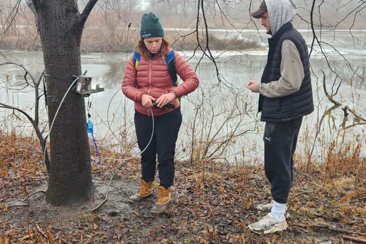 Liza Lehrer and Joe Garner maintain a camera trap in January 2024