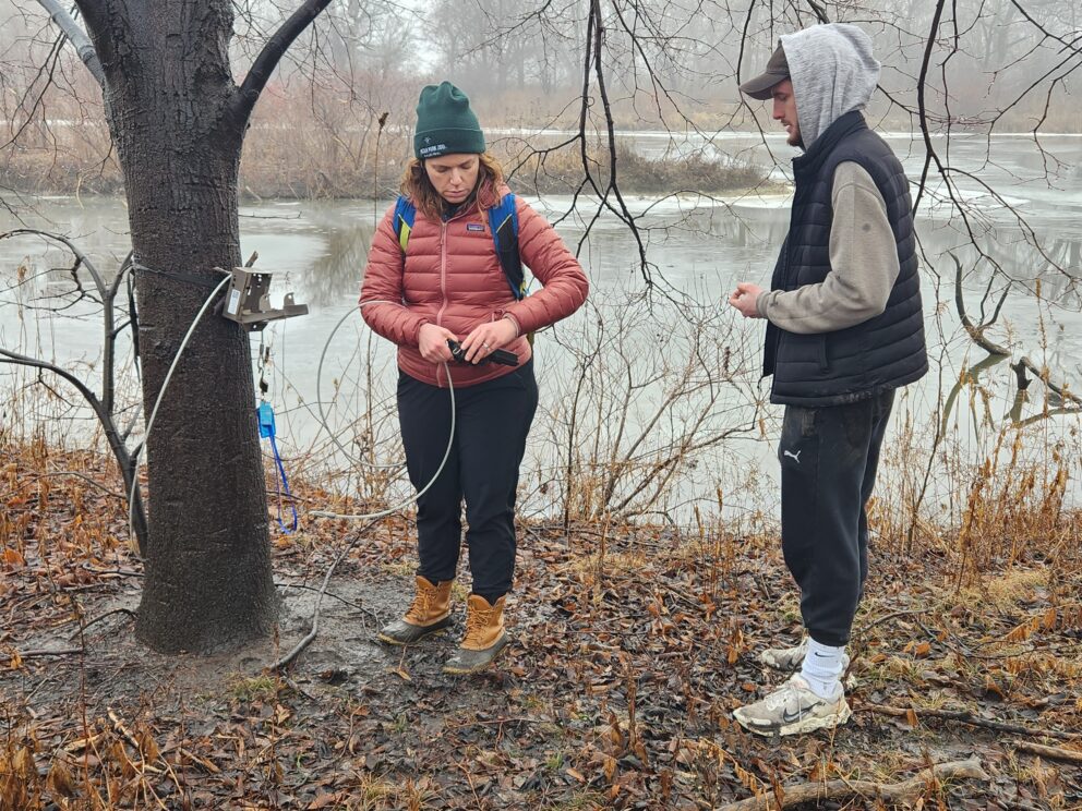 Liza Lehrer and Joe Garner maintain a camera trap in January 2024
