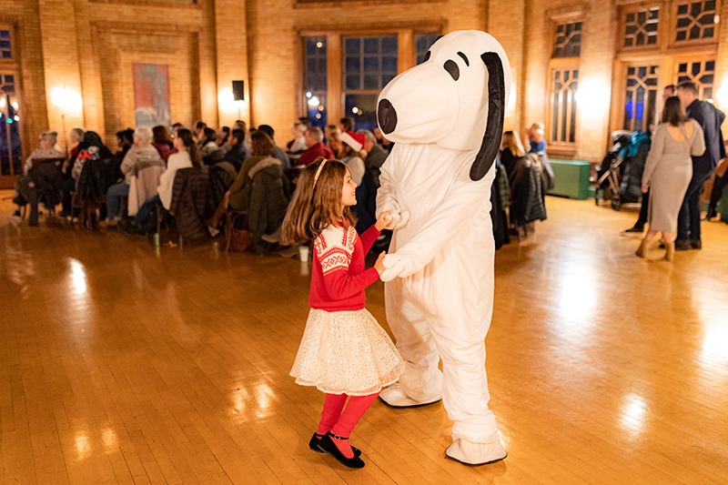 snoopy dancing with girl at event