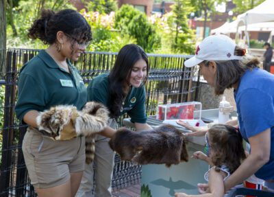 ZIP teens showing artifacts to zoo guests